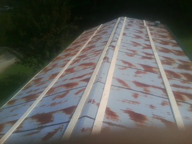 Rusted metal roof panels with new wood purlins before replacement — Storm Damage Roof Repair in Buena Vista by Roofing Brothers